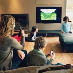 familia mirando la TV con mando a distancia